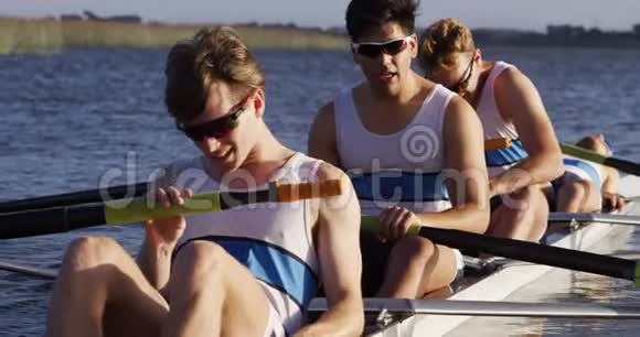 在湖上休息的男性划船队的正面景色视频的预览图