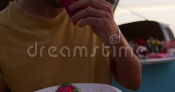 从餐车里吃玉米煎饼的年轻人视频的预览图