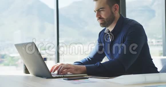 商人在他的笔记本电脑上工作视频的预览图