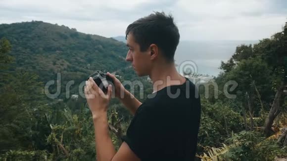 人类旅行者在山上拍摄风景如画的景色专业摄影师旅行者拍照视频的预览图