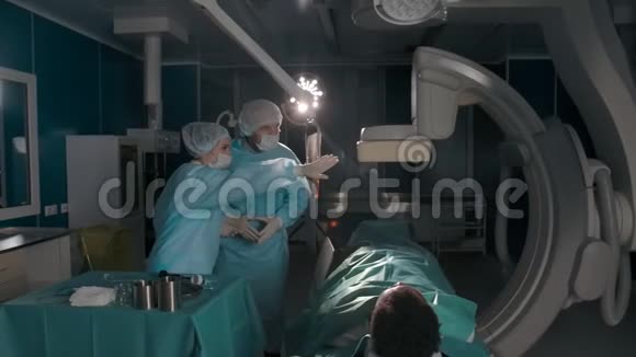 外科医生在现代手术室与病人交谈视频的预览图