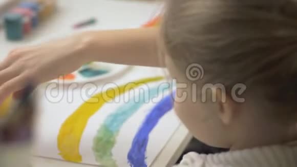 两个女孩用水彩和画笔画出彩虹孩子们共同的创造力视频的预览图