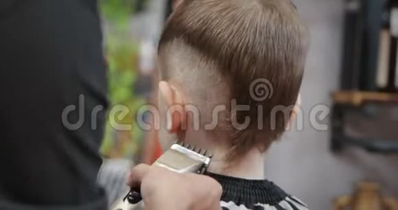 当冠状病毒流行时孩子们在沙龙理发小男孩理发孩子们头发视频的预览图