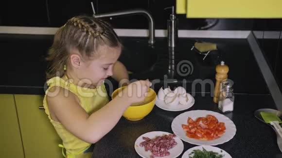 聪明的女孩学做饭年轻的女主人孩子们用咸肉煎蛋卷做一个那不勒斯鸡蛋煎蛋卷视频的预览图