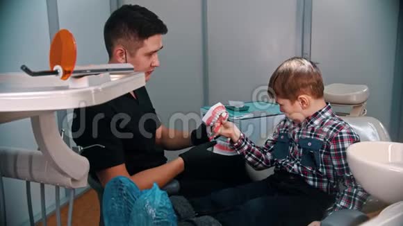 一个小男孩在现代牙科治疗解释如何刷牙的下巴模型视频的预览图