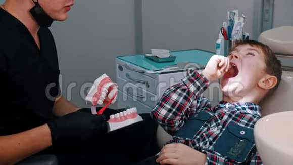 一个在牙科治疗的小男孩讨论卫生和刷牙视频的预览图