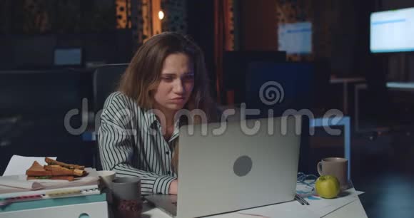 疲惫的女办公室经理在笔记本电脑上加班看上去很沮丧在她的报告中发现错误视频的预览图