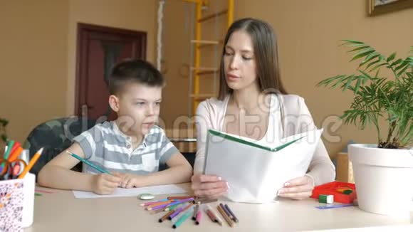 家庭教育母亲和儿子正在做艺术用品作业视频的预览图