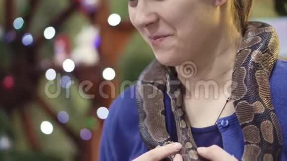 大自然女孩在动物园里抱着蛇享受野生动物保护区的远足学生在那里玩学习爬行动物4k视频的预览图