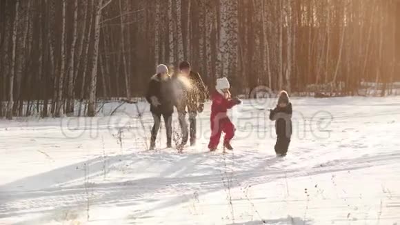 在日落时分一家人在冬天互相扔雪视频的预览图
