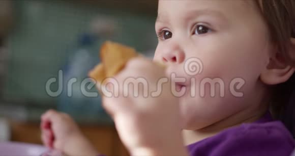 宝宝用手吃煎饼坐在孩子座位上视频的预览图