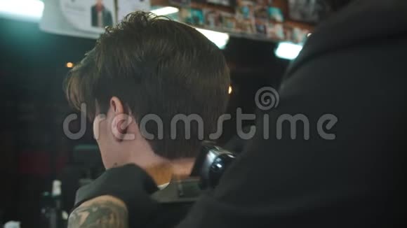 理发师在理发后用干头发上的理发器做最后的修饰视频的预览图