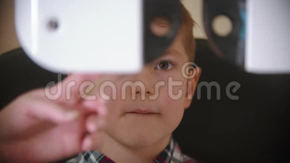 眼科诊所的一种治疗方法通过可互换的大型特殊设备检查小男孩的视力视频的预览图