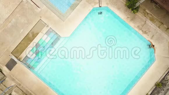 从无人驾驶飞机上观看游客在游泳池放松夏季在蓝水池游泳的青年男子视频的预览图
