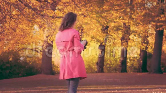 年轻时尚的女人在公园里的相机上拿着象形文字视频的预览图