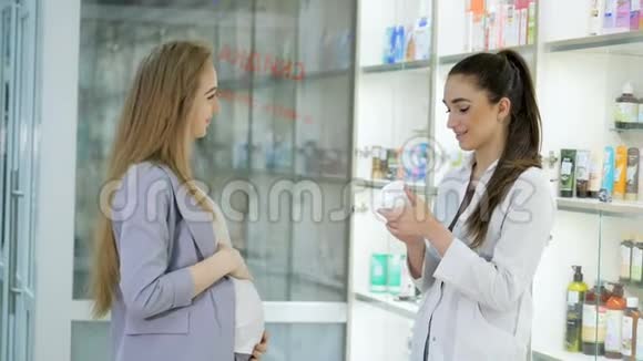 年轻女孩药剂师建议怀孕的顾客医药商店概念视频的预览图