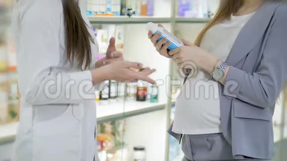 年轻女孩药剂师建议怀孕的顾客医药商店概念视频的预览图