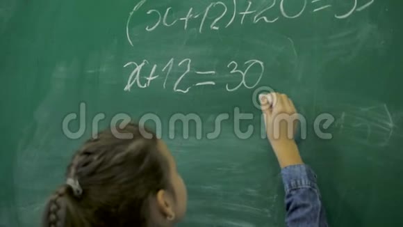 小学小女生在教室的绿色黑板上写数字视频的预览图