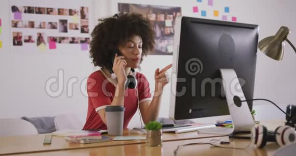 混合种族妇女在创意办公室打电话视频的预览图