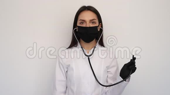 年轻护士医生摘下黑色防护面罩和听诊器女性深深地呼吸微笑着看着镜头视频的预览图