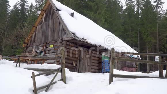 旅行者从冬天森林的木屋里出来视频的预览图