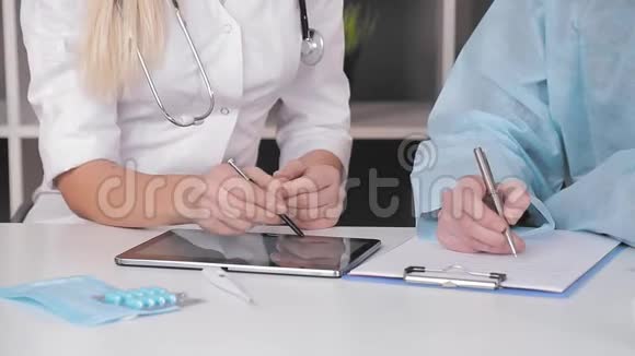 医生的特写在办公室的平板电脑上工作的双手视频的预览图