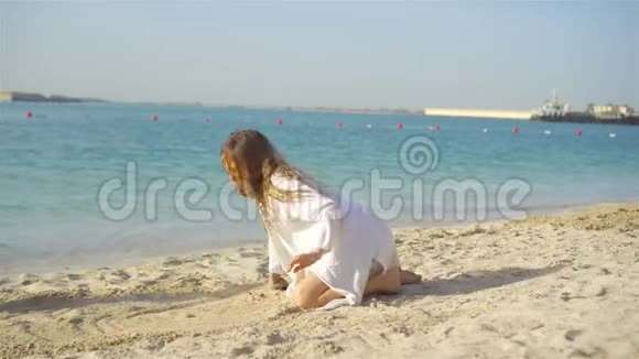 热带白海滩制作沙堡的小女孩视频的预览图