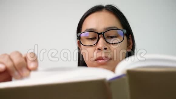 女人翻书页在图书馆看书时她的手指沿着书页移动有选择的焦点视频的预览图