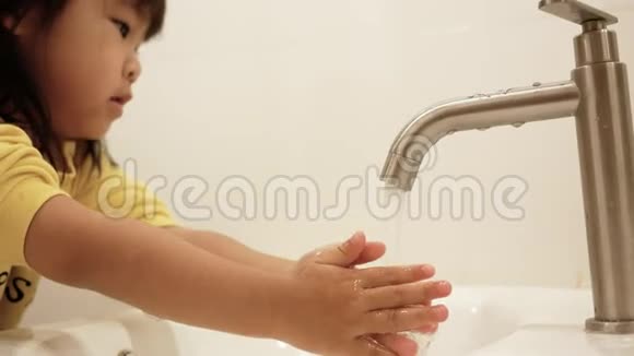 快乐的小女孩在浴室里洗手卫生保健理念视频的预览图