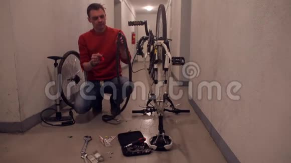 一个人试图用打火机封住自行车轮子上的一个洞视频的预览图