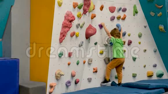 不知名的男孩在健身房练习攀岩视频的预览图