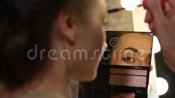 女人涂睫毛膏看着镜子视频的预览图