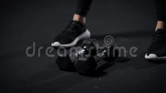 漂亮的运动型女人在运动训练期间在体操馆做哑铃和蹲体动作视频的预览图