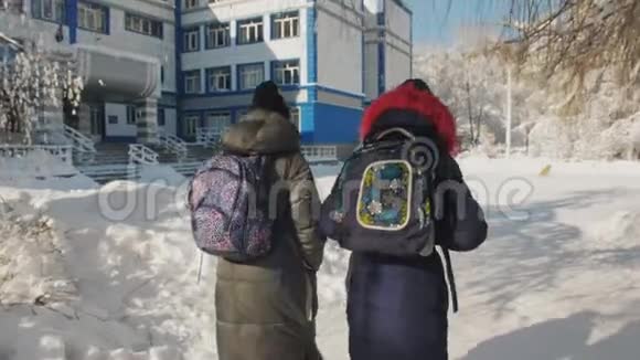 两个有背包的十几岁女孩的朋友将在冬天上学后景视频的预览图