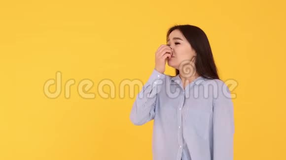 年轻女孩亚洲女孩在黄色背景下哭泣女人不高兴视频的预览图