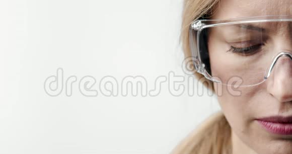 戴防护眼镜的成熟医生的半张脸视频的预览图