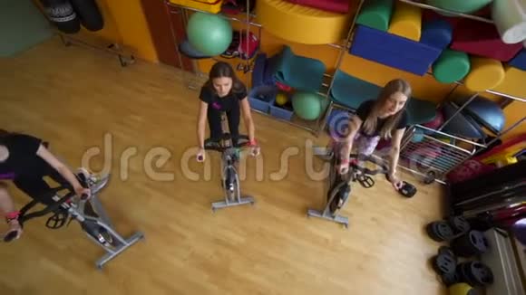 青年女子团体在健身房骑自行车的最佳视角视频的预览图
