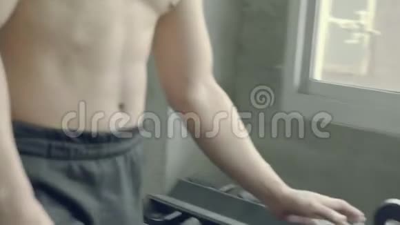 亚洲年轻人把哑铃放在架子上在健身房锻炼身体视频的预览图