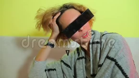戴黑眼镜的女孩在黄色背景上摆姿势视频的预览图