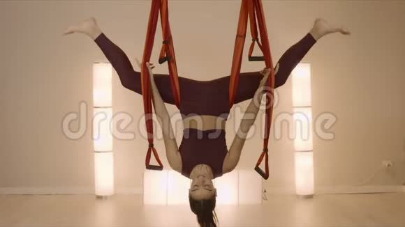 女人倒在吊床上冥想运动反性瑜伽的女运动员视频的预览图