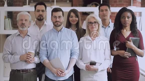 严肃快乐的专业商业团队站在办公室视频画像视频的预览图