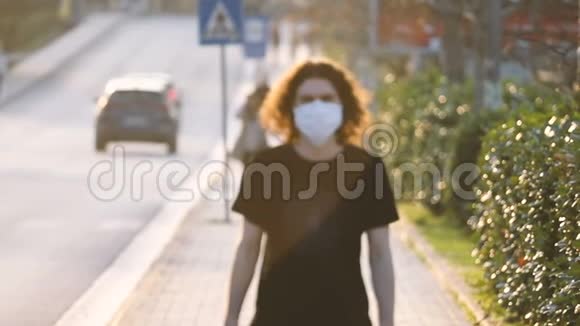 一个年轻人慢吞吞地带着防护面具走在街上视频的预览图