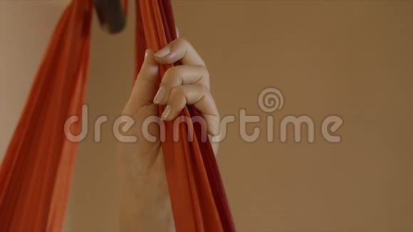 在飞瑜伽工作室拿吊床的女人在工作室练习空中瑜伽的女孩视频的预览图