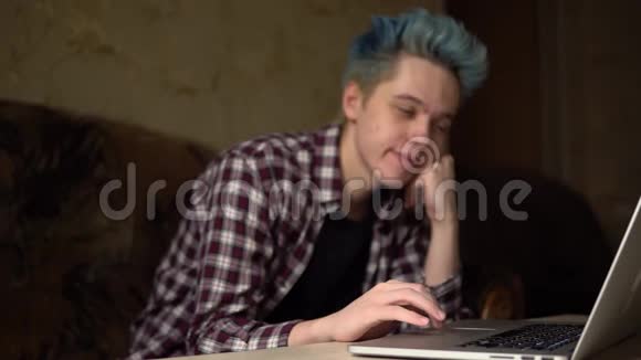 恋爱中的年轻人看着笔记本电脑微笑着一个人坠入爱河视频的预览图