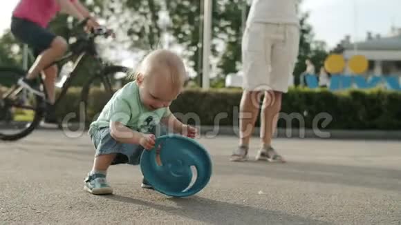 微笑的幼儿在游乐园玩可爱的孩子在外面扔飞盘视频的预览图