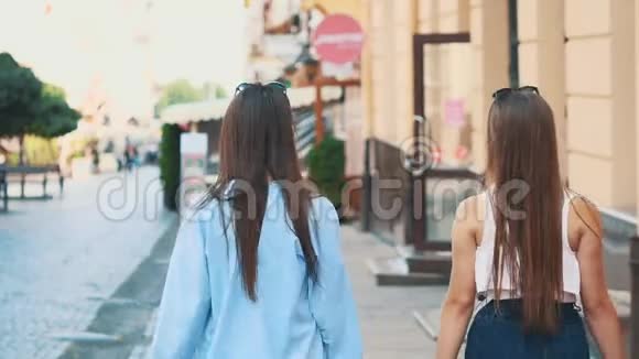 两个漂亮的女孩在购物后漫步街头玩得很开心后景复制空间4K视频的预览图