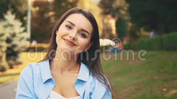 快乐的女孩真诚地微笑在模糊的夏季公园背景快关门复制空间4K视频的预览图