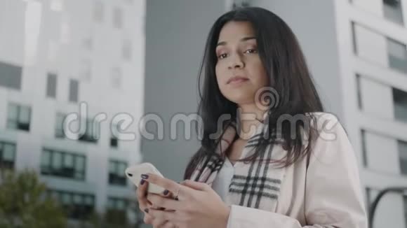 女商人用手机发短信待在外面的女经理视频的预览图