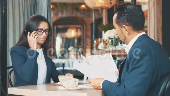 两个商人吃商务午餐餐馆或咖啡店里的男人和女人正在喝咖啡视频的预览图