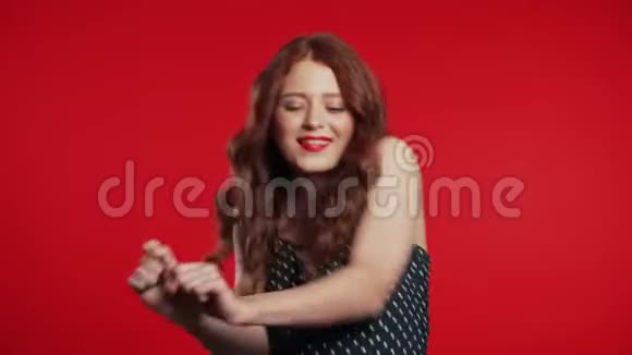 美丽的女人美丽的头发有趣的舞蹈在红色的工作室背景视频的预览图